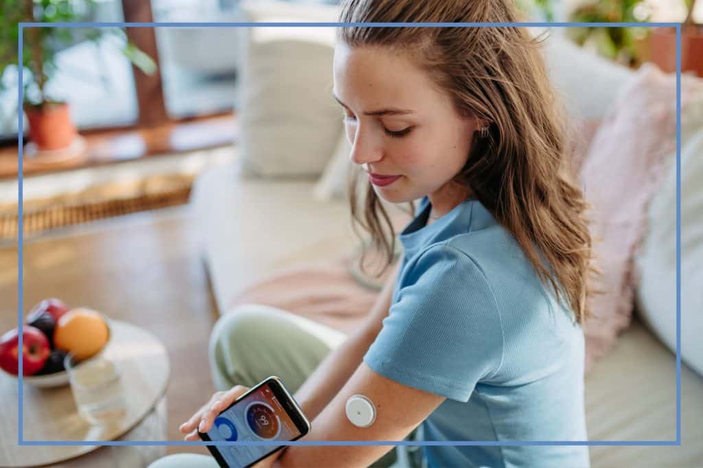 woman with brown hair scanning her Libre sensor.