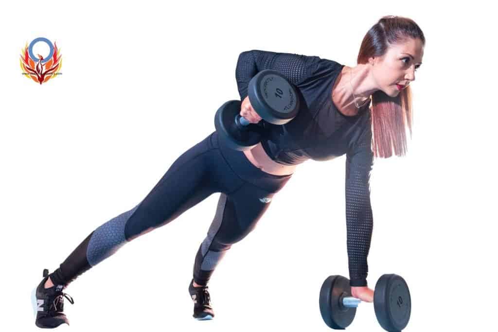girl on the floor lifting dumb bells