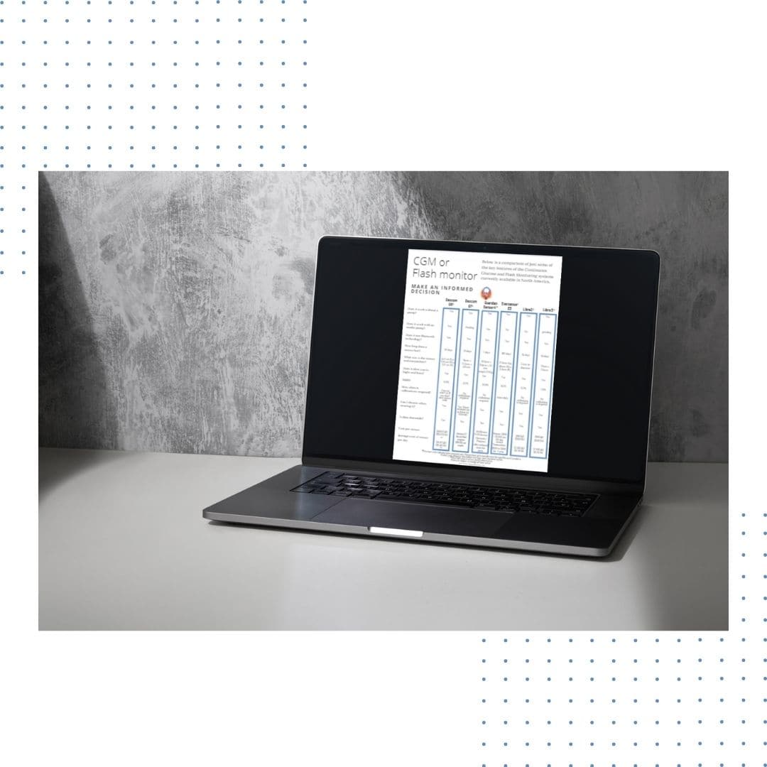 grey back drop. Laptop sitting open on while desk. On the screen is an CGM comparison chart from Diabetes Advocacy